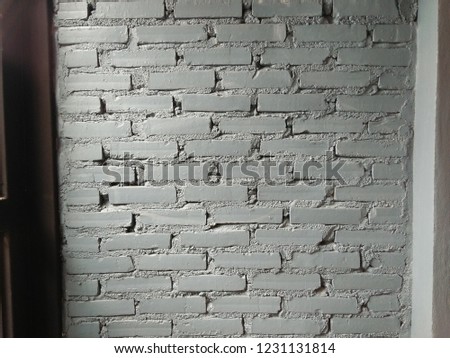 Gray brick wall with sunshine.