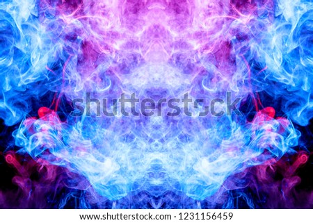 Cloud of blue and pink smoke  in the form of a skull, monster, dragon  on a black isolated background. Background from the smoke of vape. 