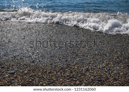 small waves on a pebble beach on the black sea
