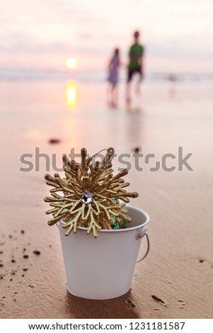 Golden Snowflake In A White Bucket On The Beach At Christmas Sunset In California