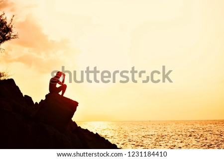 One Moment On The Rock in beach When sunset So Beautiful holiday moment in your time siting for thinking post for relaxing yoga thaiperformance time in silhouette pictures