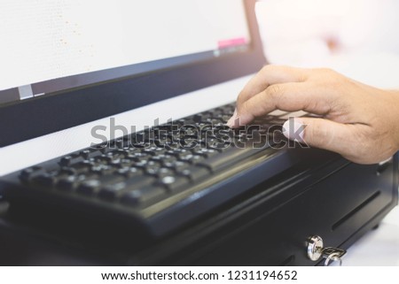 Selective focus finger’s male on keyboard on pos cashier desk.