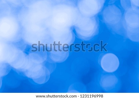 Abstract Blue Bokeh with soft blurred background nature blurry light party in vintage style warm pastel shimmering and faded cool colorful defocused circular. Shiny copy space for holiday card xmas. 