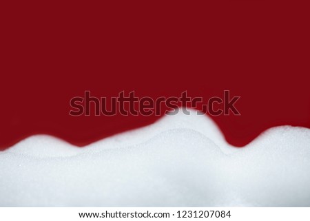 White bubbles soap with blurred red background for products presentation.