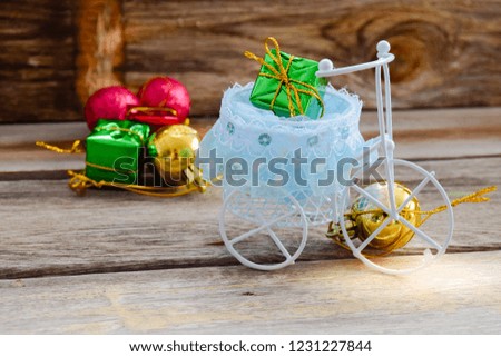 Gift box and white bicycle decoration on wood background. Celebration concept.