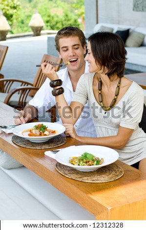 A young couple on vacation eating lunch at a relaxed outdoor restaurant Royalty-Free Stock Photo #12312328