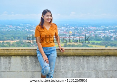 Asian girl standing with city view at Wat Phra That Khao Noi, nan, thailand