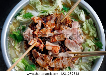 Thai barbecue Grill Pork on hot pan buffet, Moo-gata Pork pan It's traditional Thai style BBQ, barbecue buffet pig pan and vegetables in soup, Cooking barbecue pork Fatty foods, Moo Kra Ta (thai word) Royalty-Free Stock Photo #1231259518