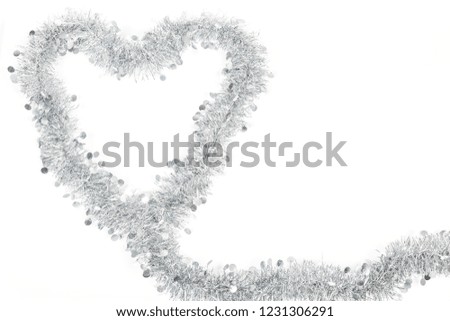 Christmas silver grey garland decoration photo as a heart for love emtion on white background.