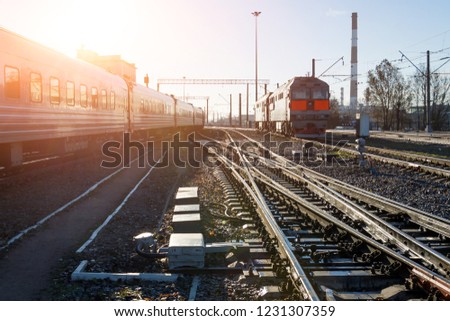 Passenger train cars train runs on the tracks station , during a beautiful sun day