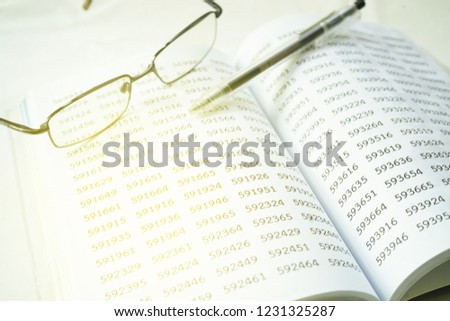 Image of eyeglass and pen on empty book. financial concept, selective focus.