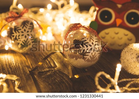 Vintage Christmas background with christmas baubles on wooden background over christmas lights.