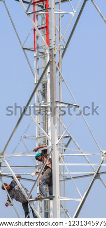 Painting cell phone antennas and the internet to enhance beauty by young hard-bodied laborers with audacity to reach heights is a dangerous job.