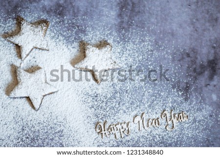 Cookies in the form of stars on a concrete background covered with icing sugar selective focus to copy text