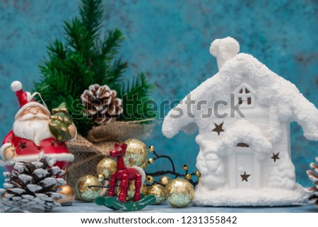 Christmas background with Christmas decorations. Floral decorations. Blue background with a snow-white winter home. Christmas decoration for postcards. Toned image. Plenty of copy space