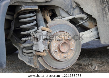 Car brake repair with removed rear wheel - brake disc brake caliper, shock adsorber, spring, hub, lever