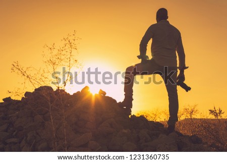  photographer taking pictures at sunset. Image with copy space.