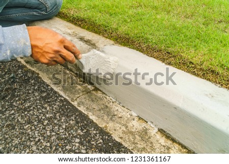 Construction worker painted the concrete edge, Construction worker with shovel.