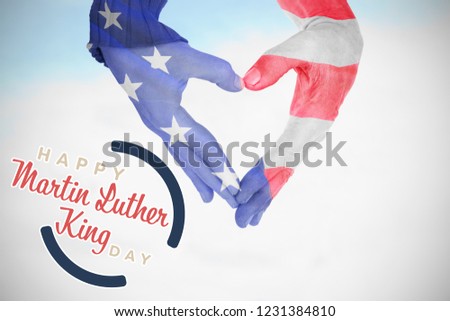 USA flag painted on hands making heart shape against blue sky with clouds 