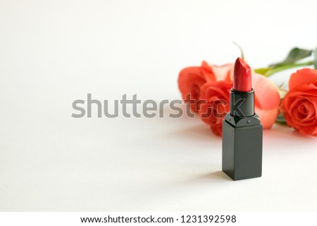 Beauty cosmetic white background with red lipstick and roses. Decorative composition with cosmetics and flowers. Makeup essentials, Cosmetic products. Feminine Modern fashion mockup, copy space.