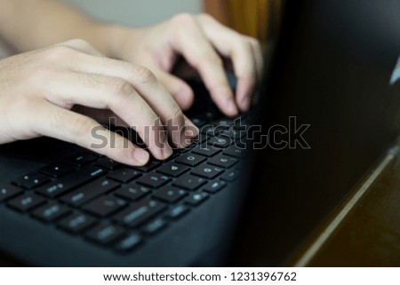 Business man using laptop computer. Male hand typing on laptop keyboard. Selective focus