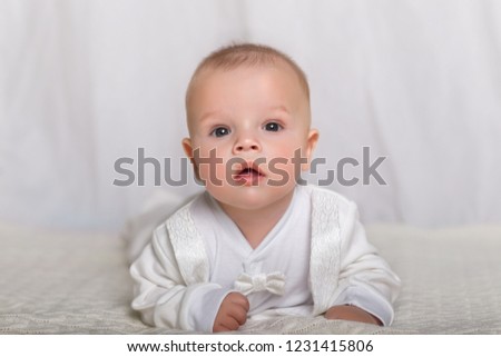 baby in white tuxedo on a white background.