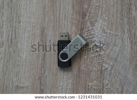 Flash drive on brown wooden background