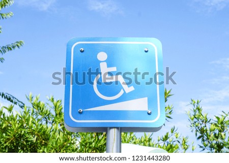 Blue symbols and disability symbols in the park.