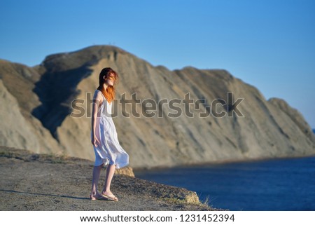 woman in flips and dress on the nature of the mountain sea                      