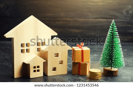Wooden houses and Christmas tree. Christmas Sale of Real Estate. New Year discounts for buying house. Purchase apartments at a low price. Winter resort and vacation. Holiday discounts.