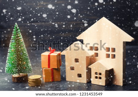Wooden houses and Christmas tree. Christmas Sale of Real Estate. New Year discounts for buying house. Purchase apartments at a low price. Winter resort and vacation. Holiday discounts.