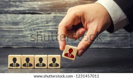 wooden blocks with a picture of workers. the businessman or CEO removes / dismisses the employee. management within the team. control arm. demotion. resignation. human resource management