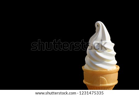 Vanilla Soft Serve Ice Cream Cone Isolated on Black Background with Free Space for Text and Design