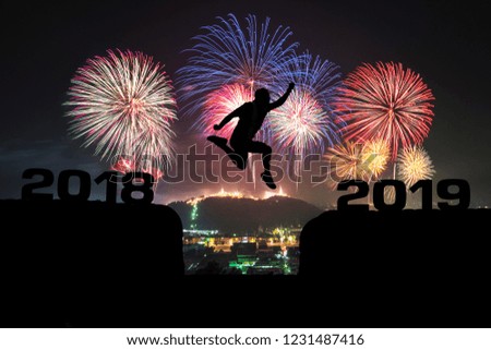 a man jumping from year 2018 to year 2019.background is firework and mountain.