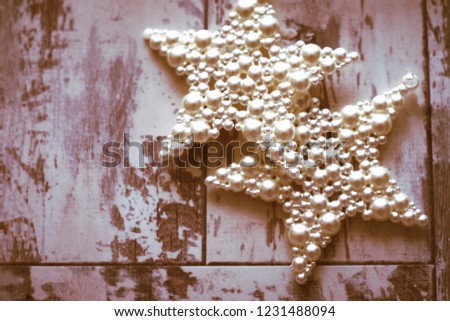 Christmas pearl white stars on a wooden background 