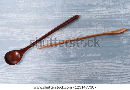 spoons for spices, on a wooden background, composition for oriental restaurants