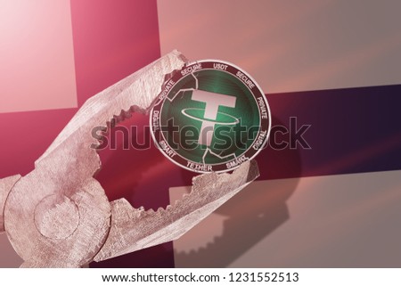 Tether (USDT) coin being squeezed in vice on Finland flag background; concept of tether cryptocurrency under pressure. Prohibition of cryptocurrencies, regulations, restrictions or security