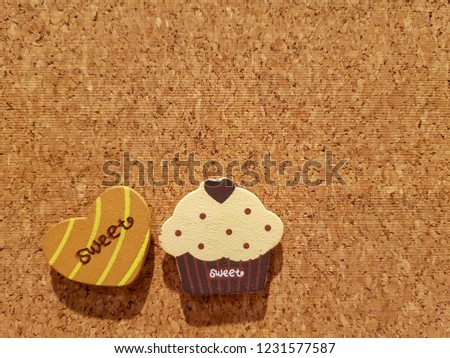Background is Medium Density Fiberboard is engineered wood wallboard made of wood chips and other recycled materials and copy space to put text and pictures on demand and has Cupcake Style.
