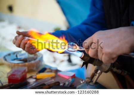 artistic work - flame melting glass and creating Christmas decoration
