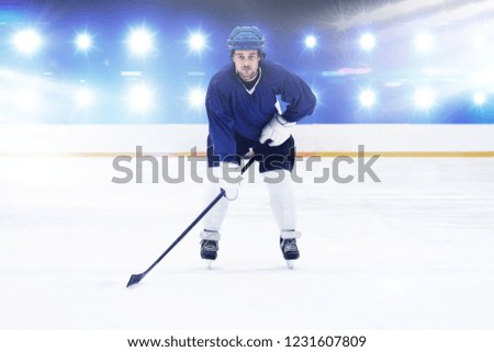 Player playing ice hockey against composite image of blue spotlight