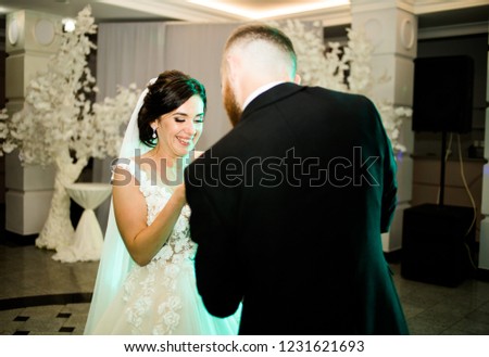 
Wedding moment cutting cake. Magnificent brides feed each other out of a spoon