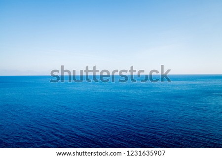 Sea blue water on half of the photo and blue sky on the other half. Concept images for display, backgrounds for gadgets, marine theme.