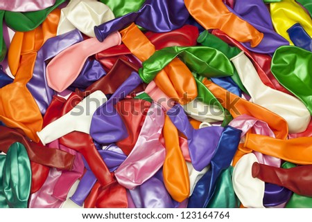 Different colored balloons stacked in pile
