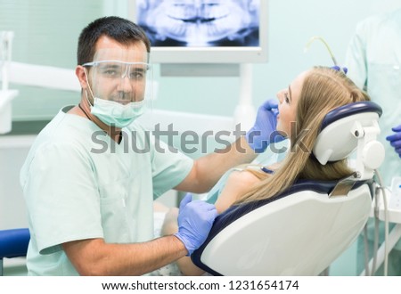 Doctor Dentist with an assistant work in a dental clinic.