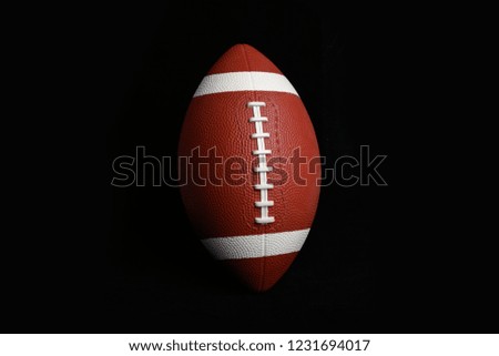 American football isolated on black , close up.