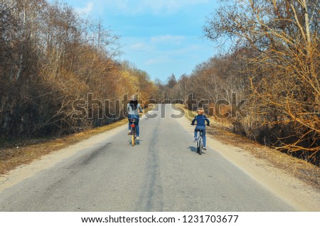 mom and son ride a bike on the way