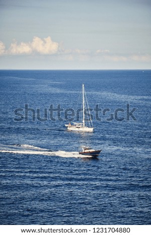 Speedboat and sailboat by the sea, travel concept.