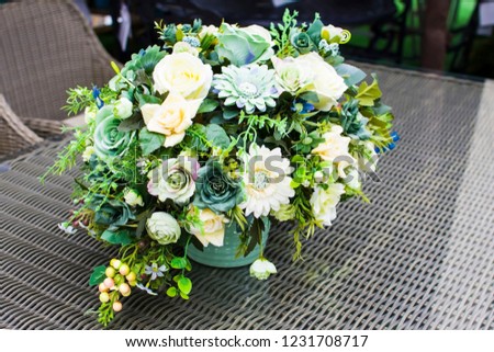 a bouquet of flowers in a vase on the table, decorating the room