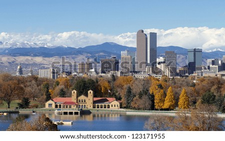 Scenic of Denver Colorado skyline, with Rocky Mountains in the background and City Park Lake in the foreground.