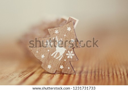 Decorative wooden Christmas trees on a gentle wooden background with a deer